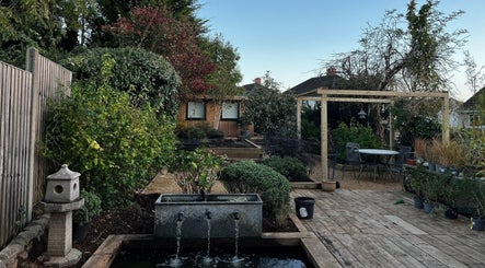Relax in the serene outdoor garden at Mon Remède Beauty, Bristol, England, GB, perfect for rejuvenation.