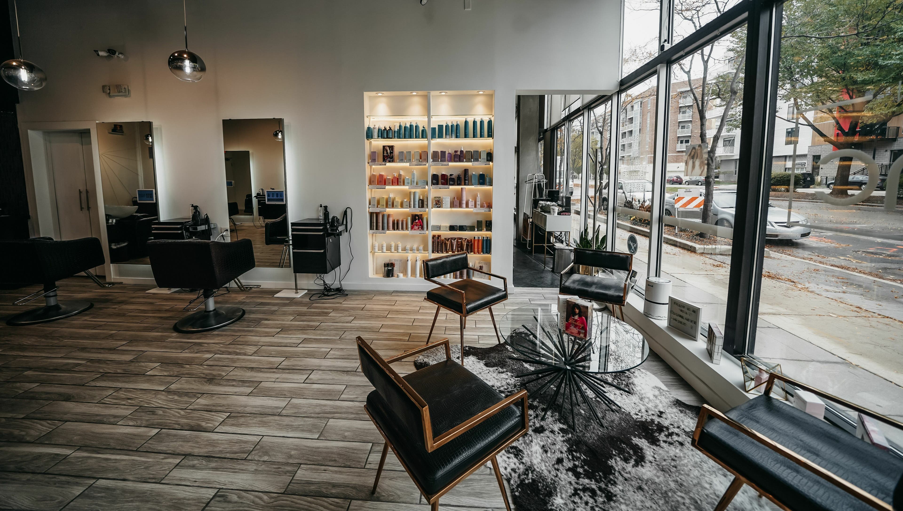 Modern interior of Salon Blānc in Milwaukee, Wisconsin, US, featuring sleek chairs and product shelves.