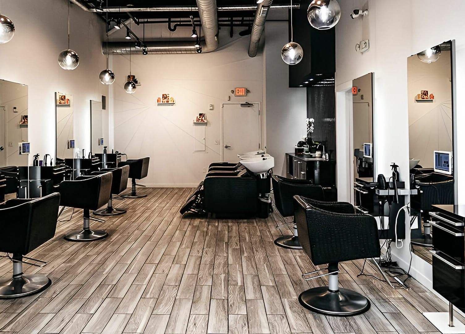 Modern salon interior at Salon Blānc, Milwaukee, Wisconsin, US featuring sleek styling stations.