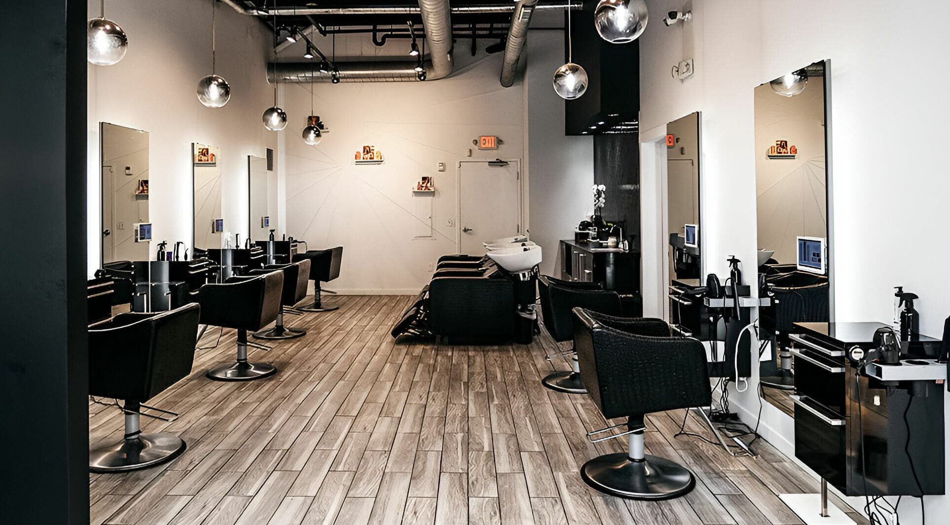 Modern salon interior at Salon Blānc, Milwaukee, Wisconsin, US featuring sleek styling stations.