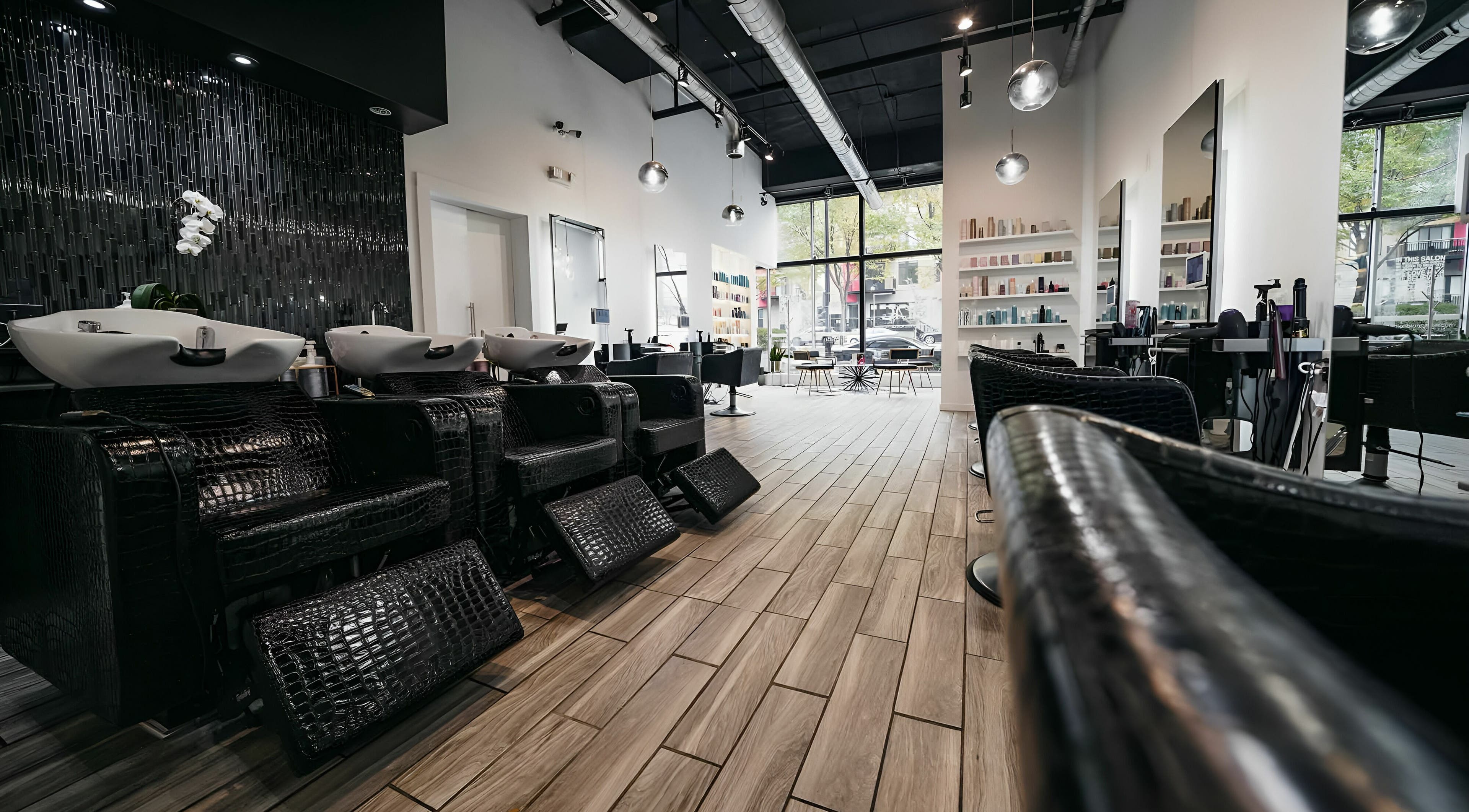 Modern interior of Salon Blānc in Milwaukee, Wisconsin, US with stylish washbasins and seating.