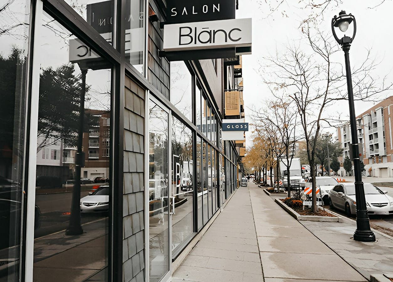 Exterior of Salon Blānc, a stylish beauty venue located in Milwaukee, Wisconsin, US along a modern streetscape.