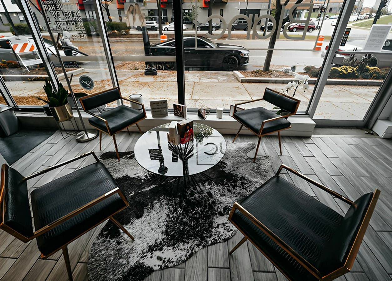 Sophisticated seating area in Salon Blānc, Milwaukee, Wisconsin, US, featuring modern decor and sleek furnishings.