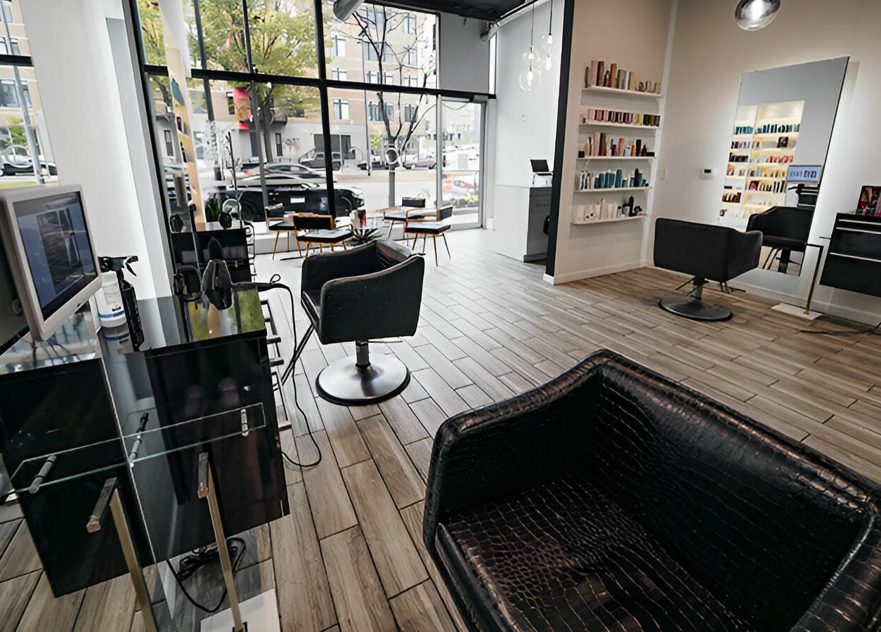 Modern interior of Salon Blānc in Milwaukee, Wisconsin, US with sleek chairs and large mirrors.