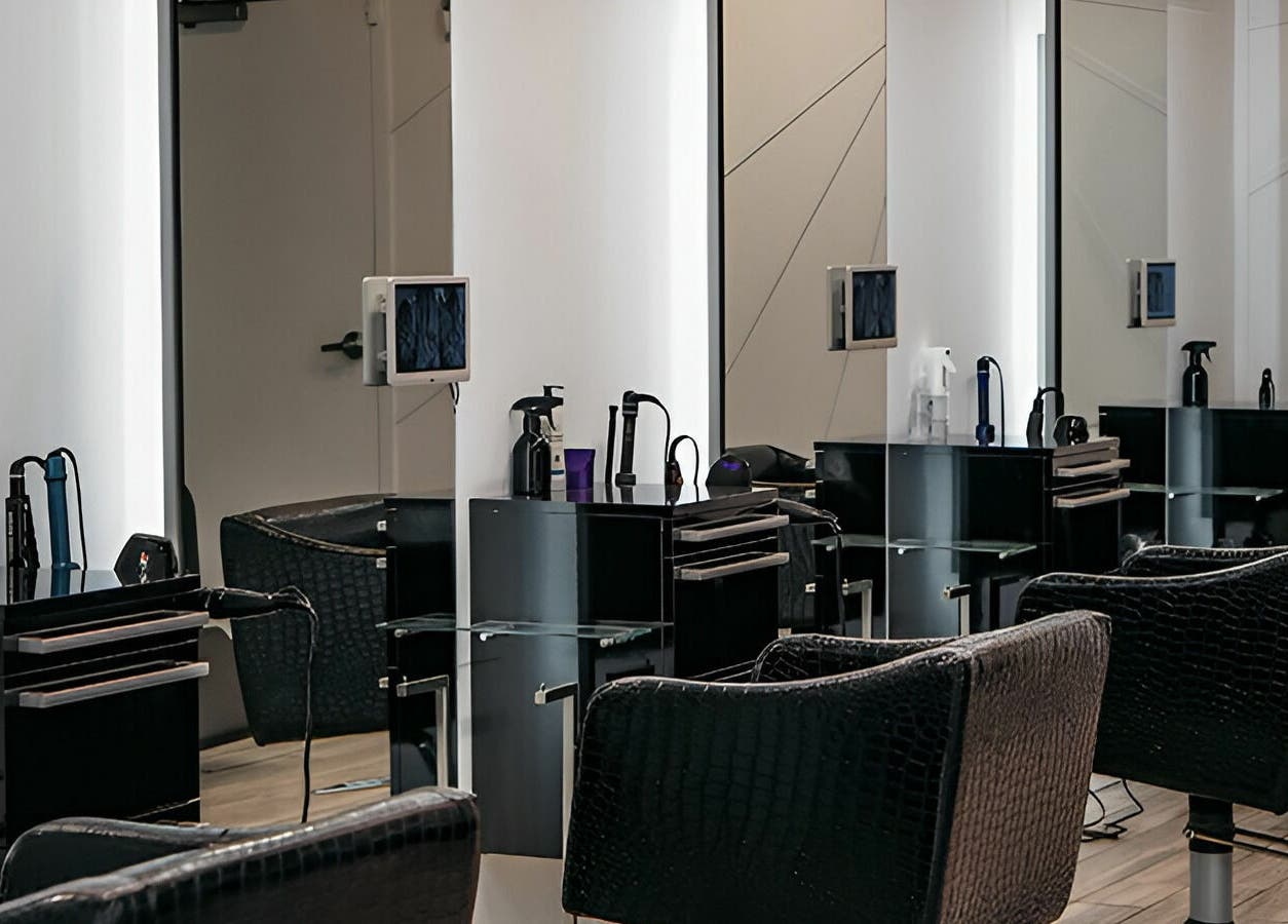 Modern salon interior at Salon Blānc, Milwaukee, Wisconsin, US with stylish chairs and sleek stations.