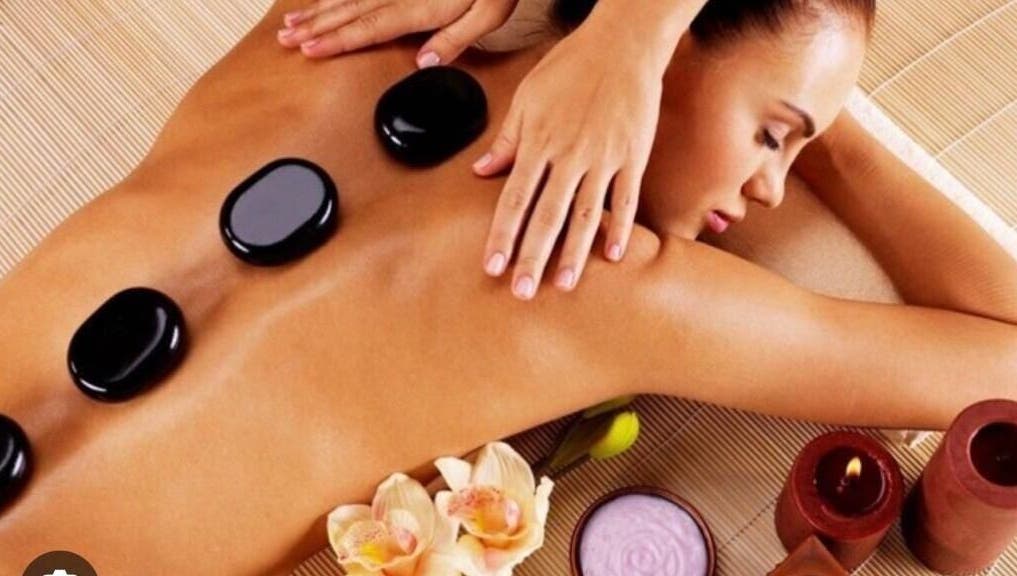 Relaxing hot stone massage at Aesthetic Home Spa | Abu Dhabi, AE, enhancing wellness and serenity.