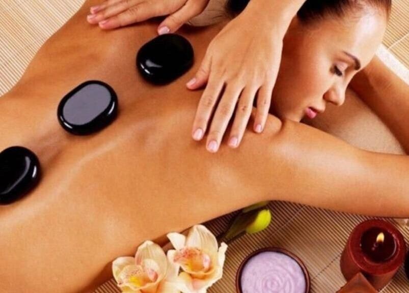 Relaxing hot stone massage at Aesthetic Home Spa | Abu Dhabi, AE, enhancing wellness and serenity.
