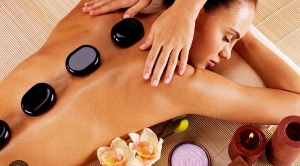 Relaxing hot stone massage at Aesthetic Home Spa | Abu Dhabi, AE, enhancing wellness and serenity.