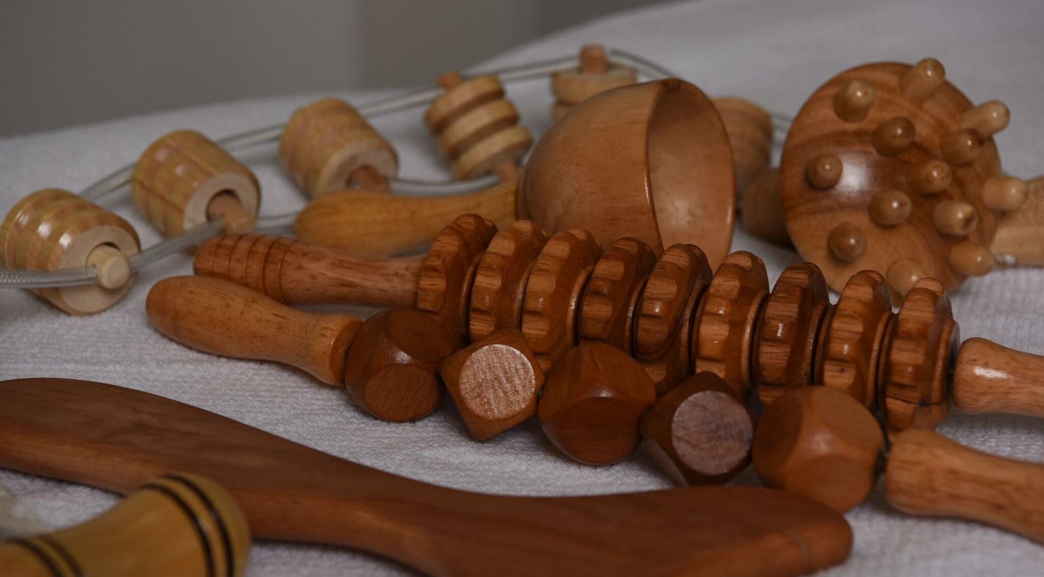Wooden massage tools at Aesthetic Home Spa | Abu Dhabi, AE, enhancing relaxation and wellness.