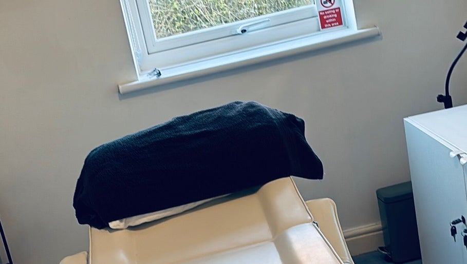 Comfortable treatment room at FernBrowsNW, Old Colwyn, Wales, GB, with a plush chair and calming decor.
