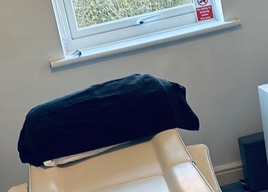 Comfortable treatment room at FernBrowsNW, Old Colwyn, Wales, GB, with a plush chair and calming decor.