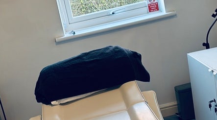 Comfortable treatment room at FernBrowsNW, Old Colwyn, Wales, GB, with a plush chair and calming decor.