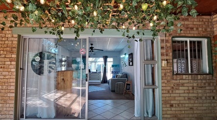 Inviting entrance of Time Out Lia’s Beauty Studio in Orkney, North West, ZA, adorned with greenery and soft lighting.