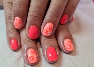 Bright floral nail art at Elegance Beauty, Bournemouth, England, GB. Perfect for a stylish summer look.
