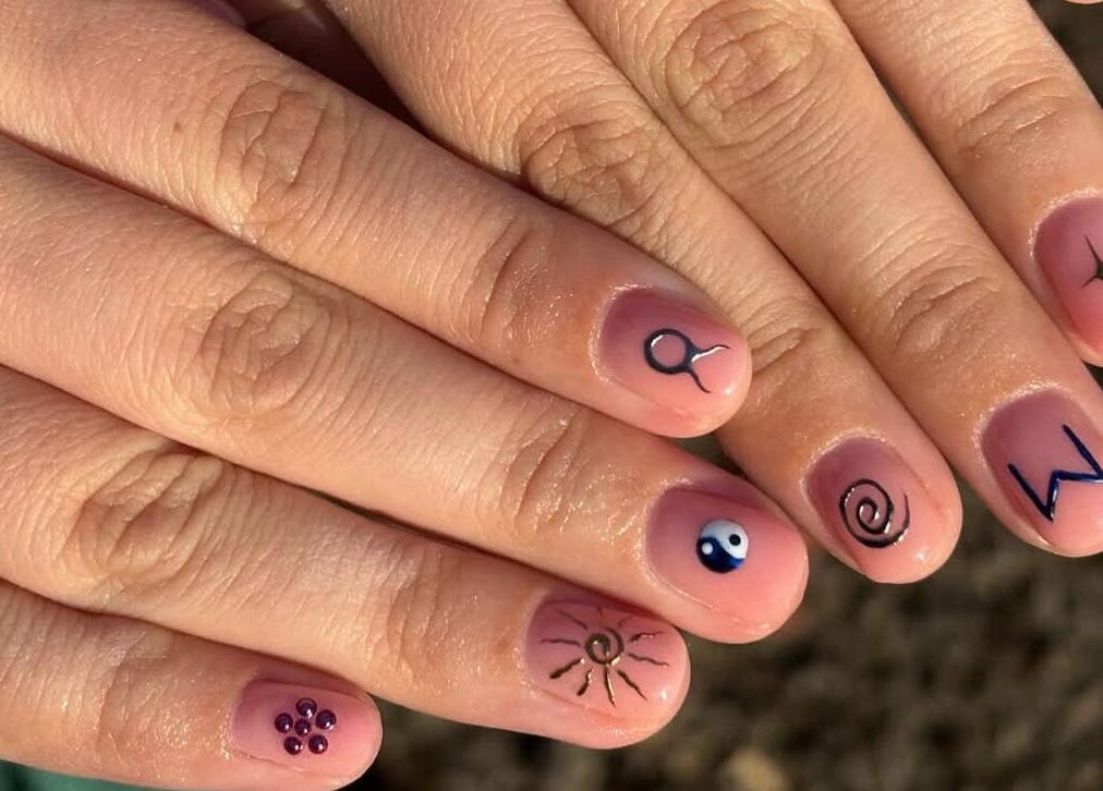 Unique nail art design featuring symbols at Nails by Ellie, Manchester, England, GB.