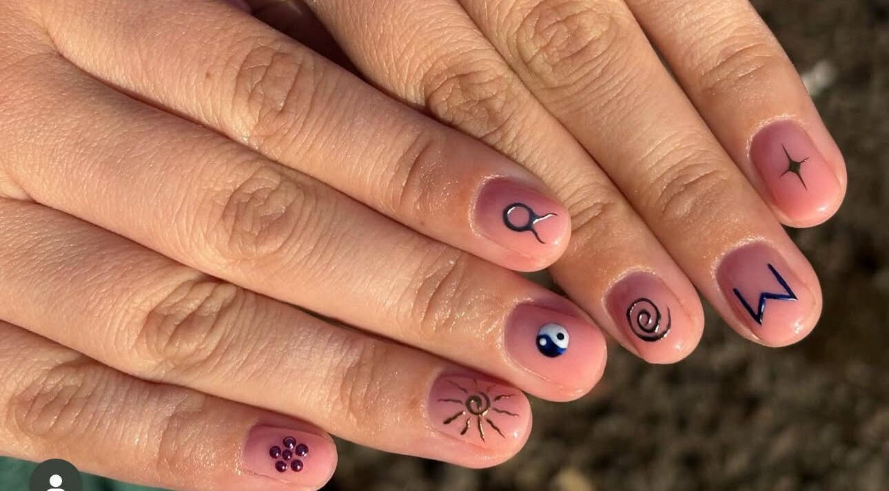 Unique nail art design featuring symbols at Nails by Ellie, Manchester, England, GB.