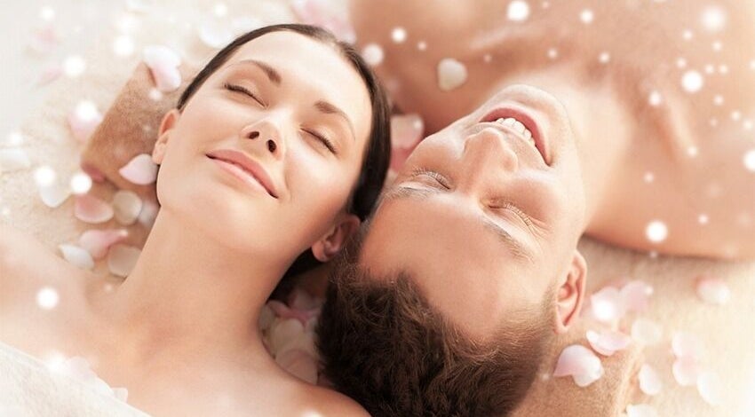 Couple relaxing with rose petals at Relax Spa, Allen, Texas, US. Experience peace and rejuvenation.