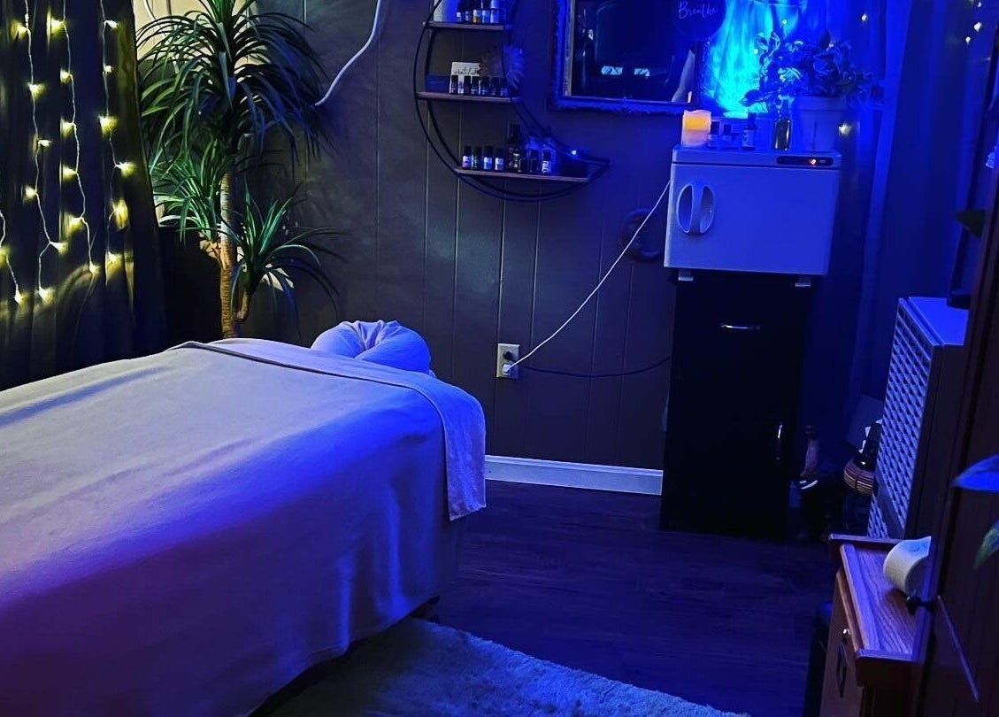 Relaxing massage room at Now and Zen Wellness LLC, Throop, Pennsylvania, US with calming lighting and decor.