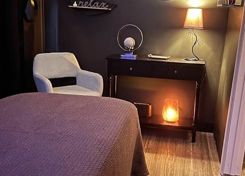 Cozy wellness room at Now and Zen Wellness LLC in Throop, Pennsylvania, US with warm lighting and relaxing decor.