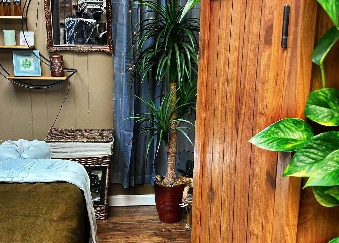 Cozy wellness room at Now and Zen Wellness LLC, Throop, Pennsylvania, US with plants and wooden decor.