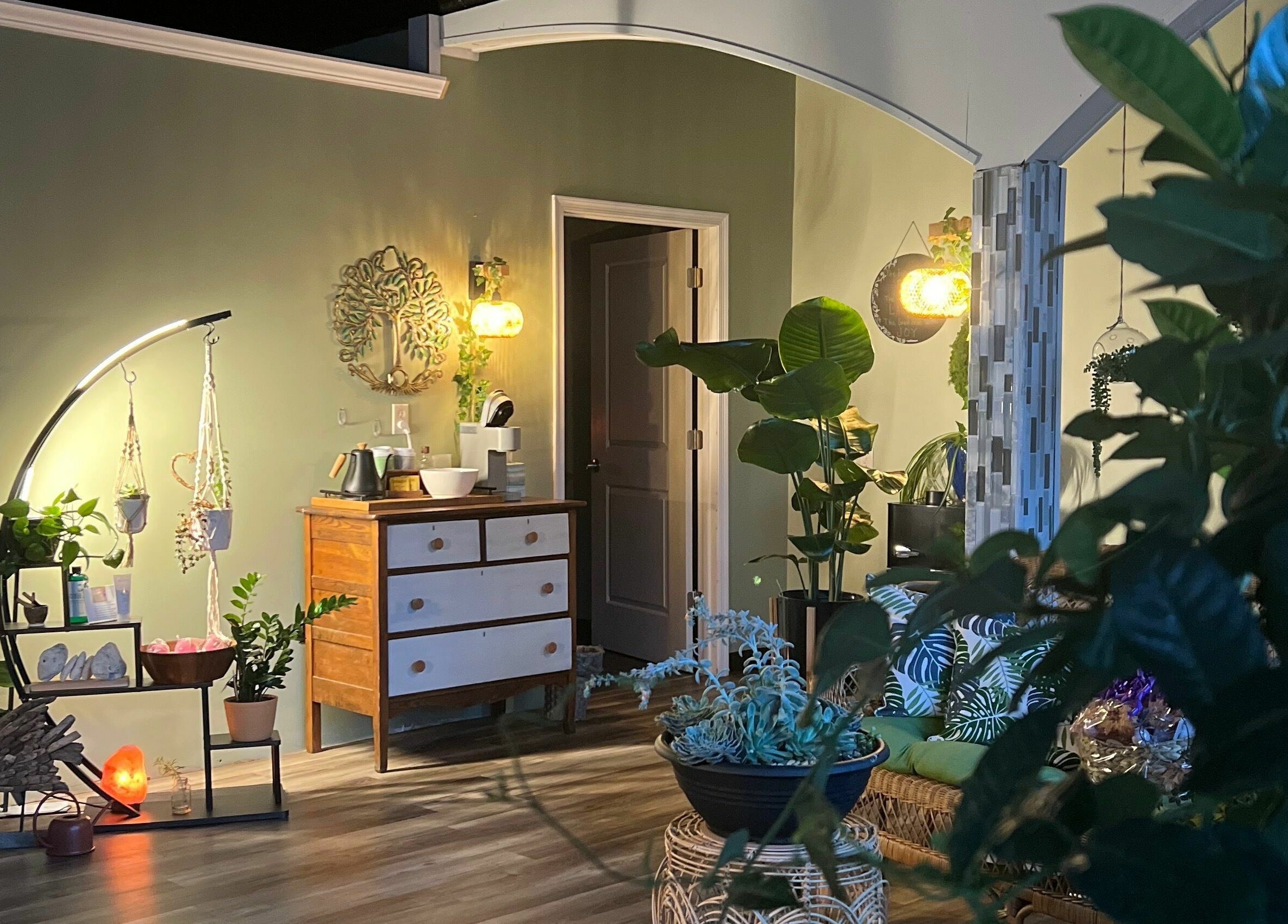 Serene wellness area at Now and Zen Wellness LLC in Throop, Pennsylvania, US with lush greenery and warm lighting.