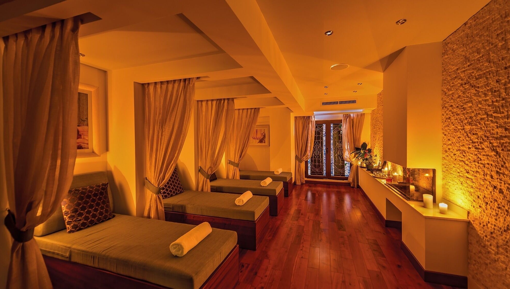 Luxurious relaxation area at The Grand Hotel Elemis Spa, Gozo, MT with soft lighting and elegant decor.