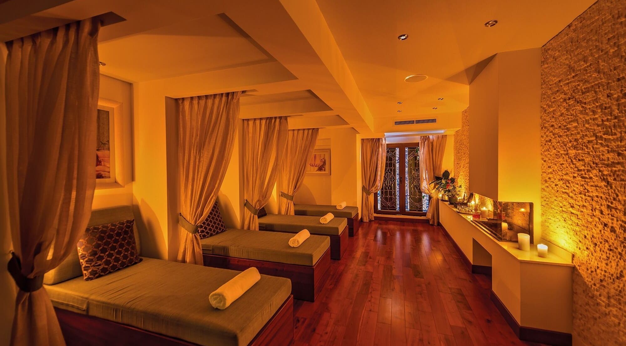 Luxurious relaxation area at The Grand Hotel Elemis Spa, Gozo, MT with soft lighting and elegant decor.