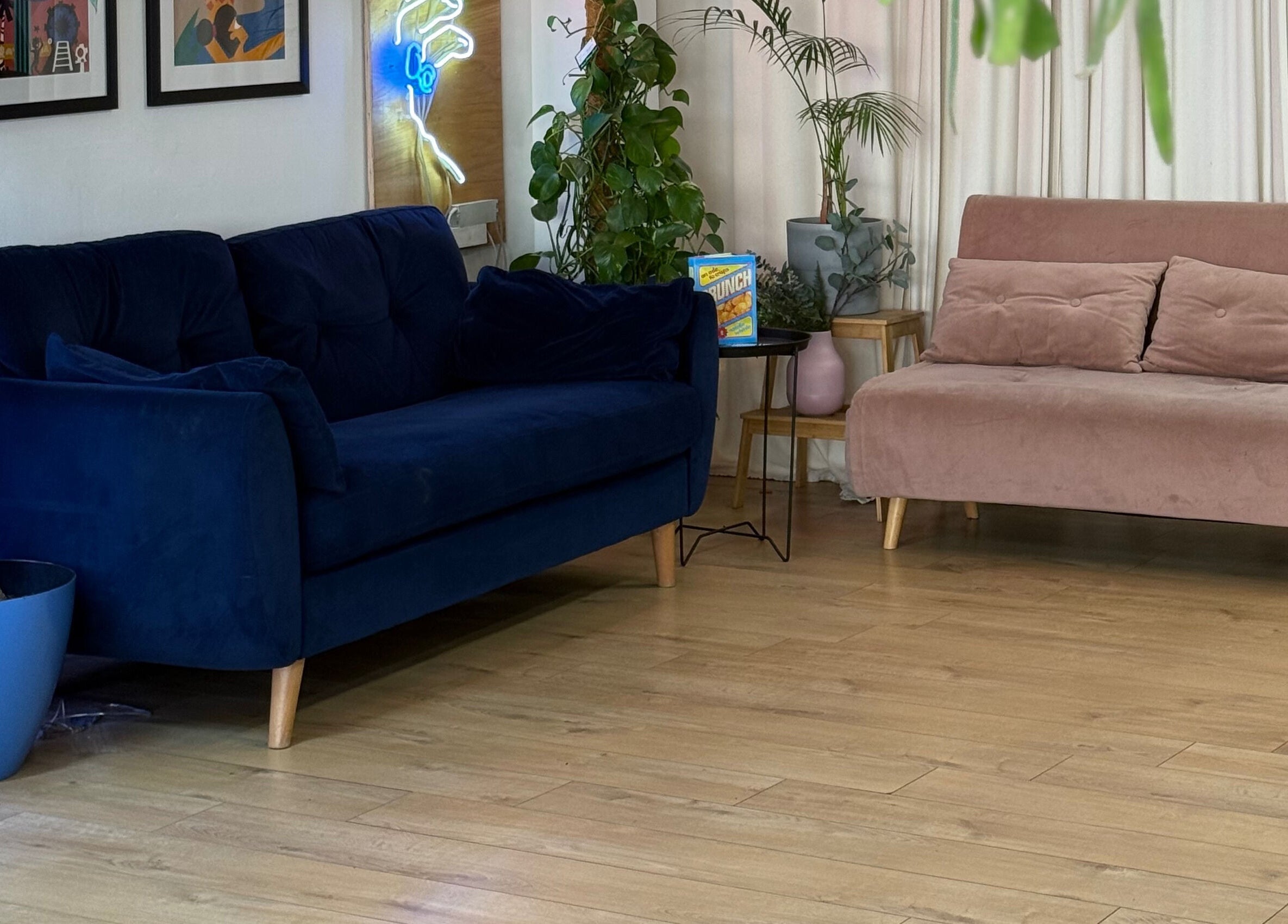 Elegant seating area at CRISP BRISTOL in Bristol, England, GB with navy and blush sofas, plants, and art decor.