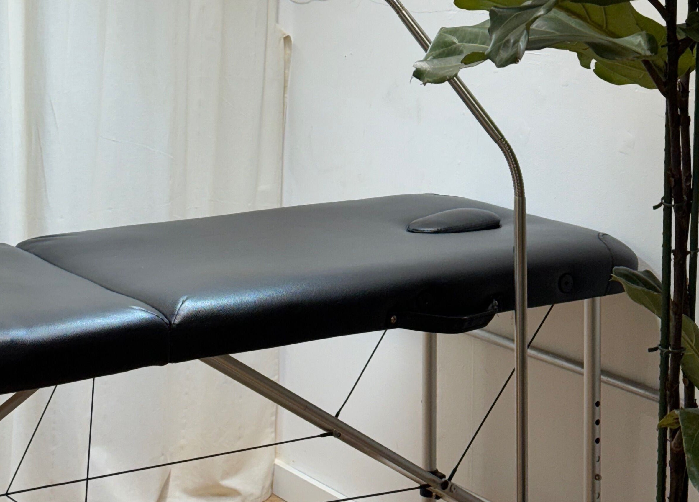 Relaxing massage table at CRISP BRISTOL, Bristol, England, GB, surrounded by green plants.