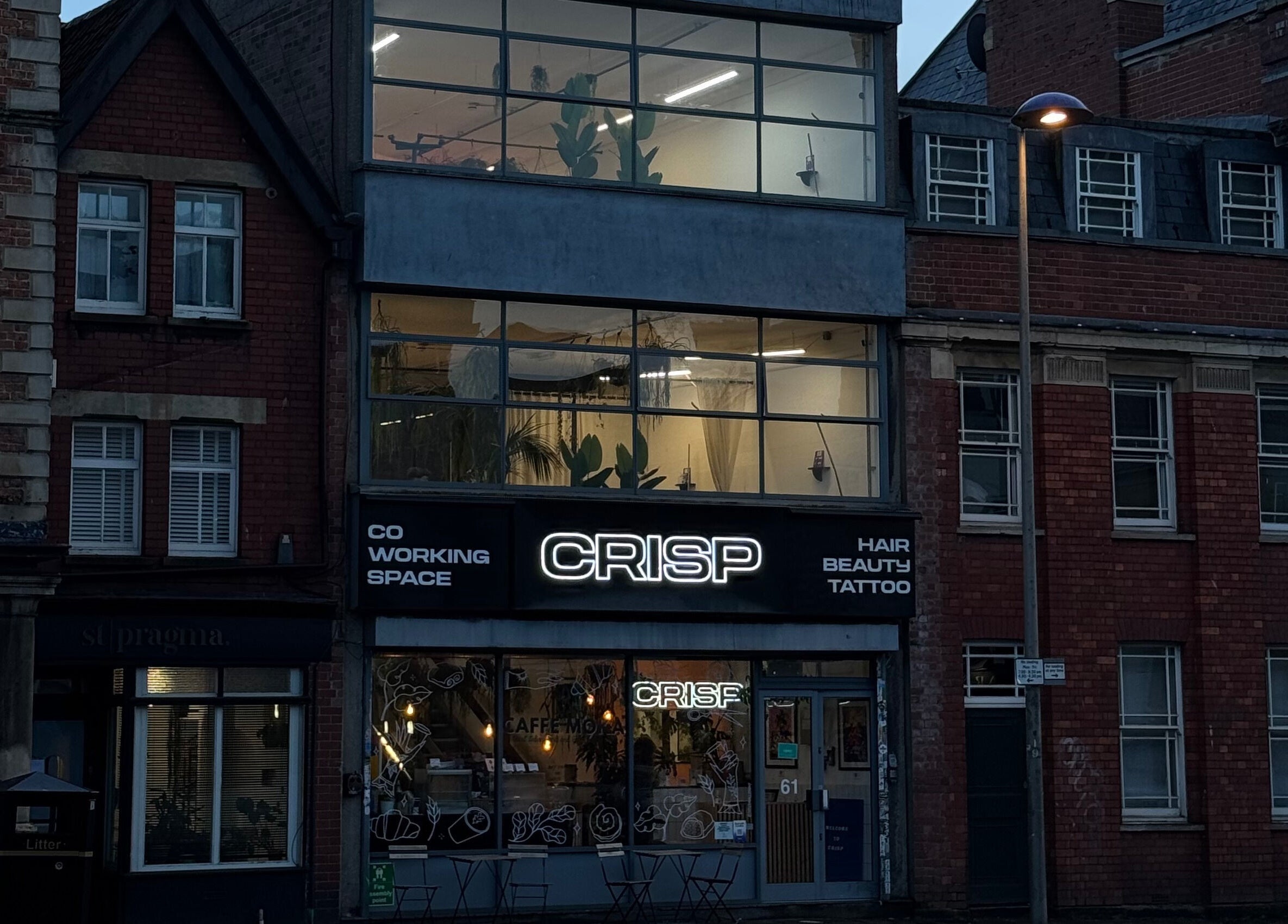 Front view of CRISP BRISTOL, a trendy beauty and wellness venue in Bristol, England, GB, with a vibrant neon sign.