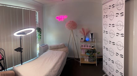 Cozy treatment room at Wicked Winks Beauty in Burpengary, Queensland, AU with neon sign and elegant decor.