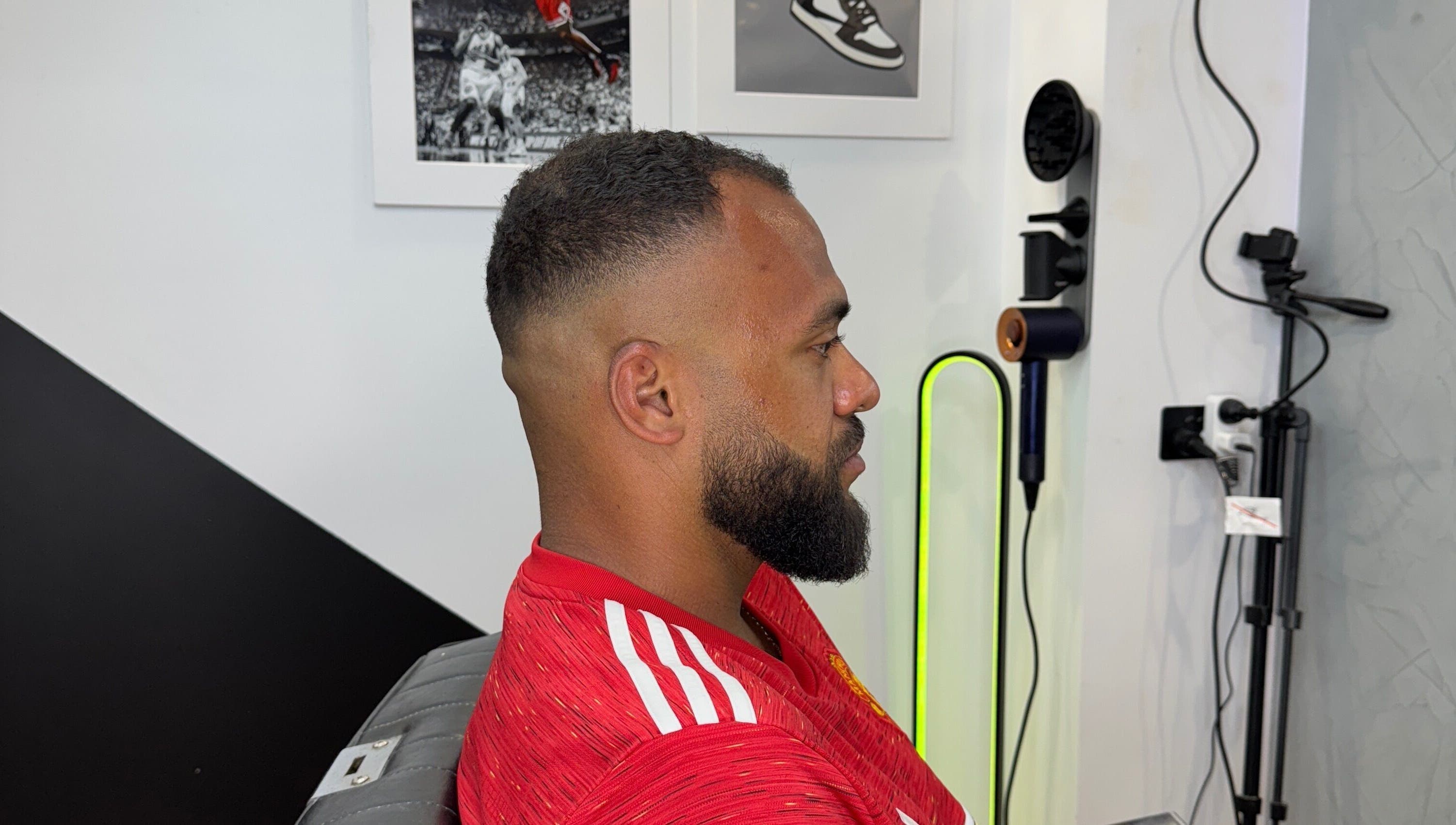 Client with fresh fade haircut at Syndicat Barber, Melbourne, Victoria, AU. Modern interior decor.