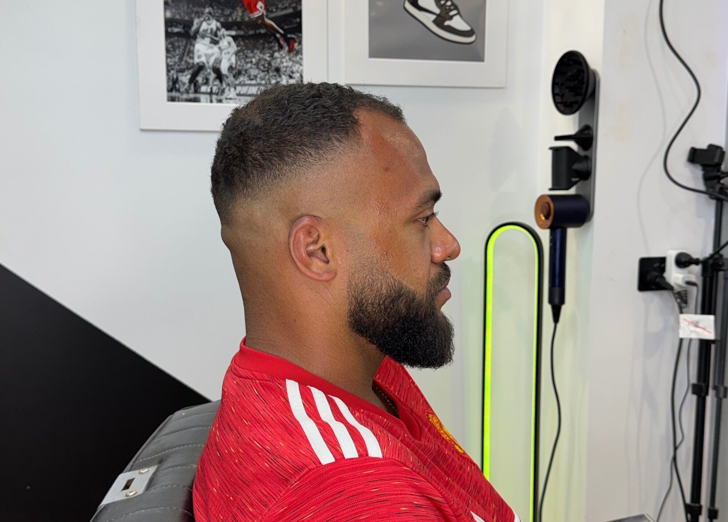 Client with fresh fade haircut at Syndicat Barber, Melbourne, Victoria, AU. Modern interior decor.