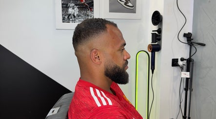 Client with fresh fade haircut at Syndicat Barber, Melbourne, Victoria, AU. Modern interior decor.