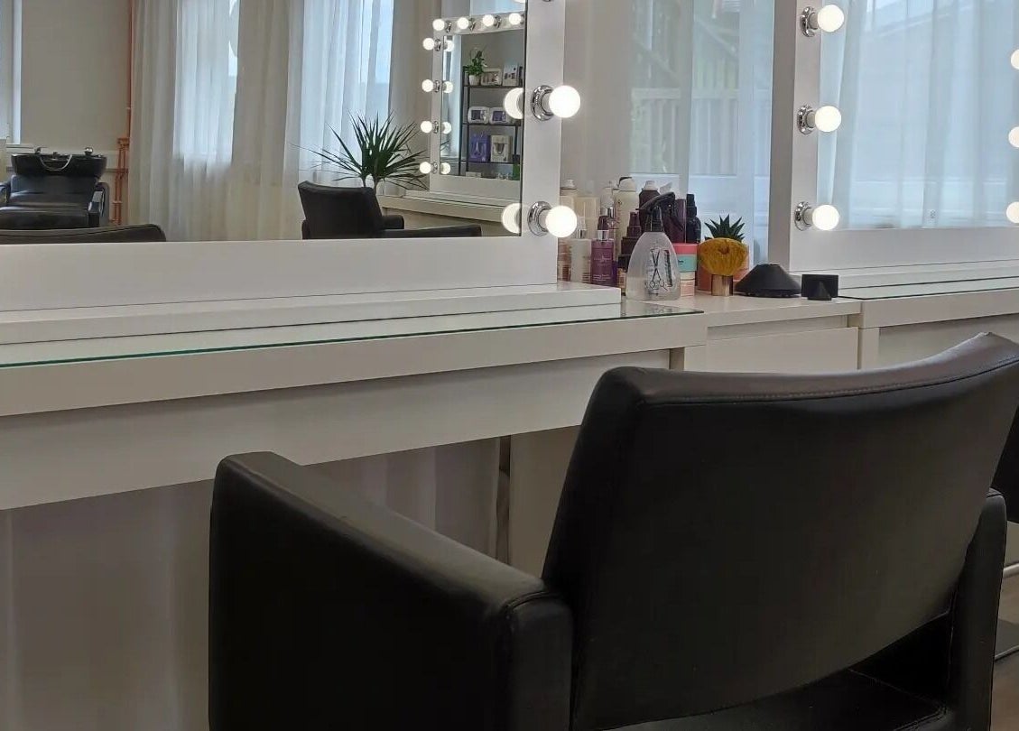 Elegant salon station at Jessica Gilbert Hair in Corbridge, England, GB, featuring chic styling chairs and mirrors.