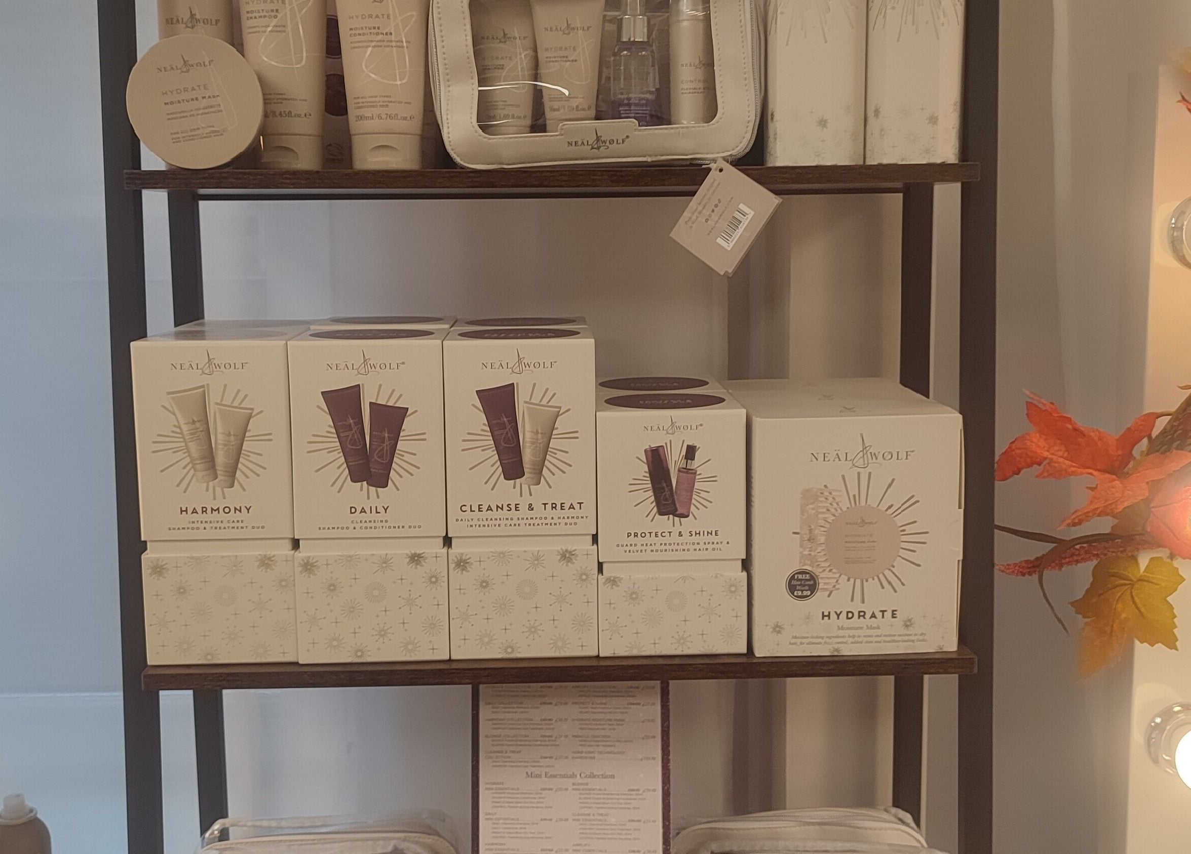 Neal & Wolf hair products on shelf at Jessica Gilbert Hair in Corbridge, England, GB, surrounded by autumn leaves.