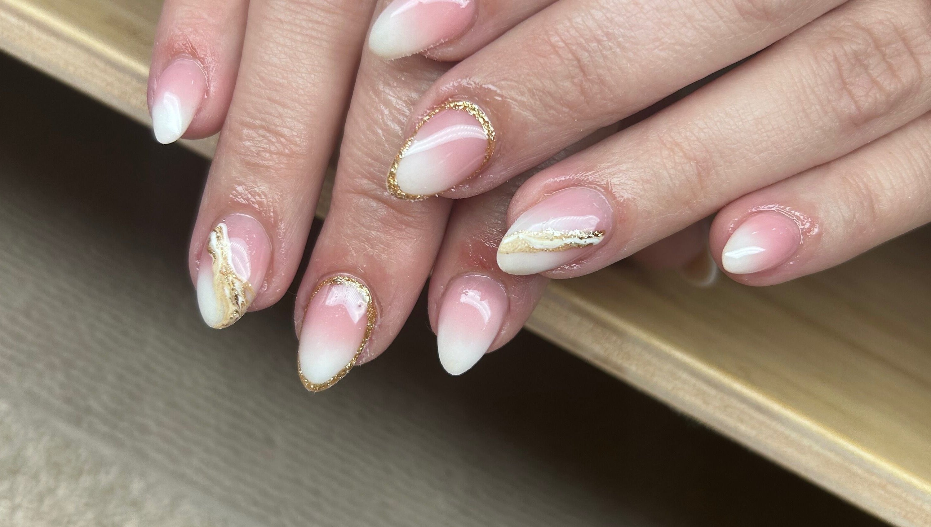 Elegant pink and white nail art at Nails By Jade, Canvey Island, England, GB. Features gold accents.