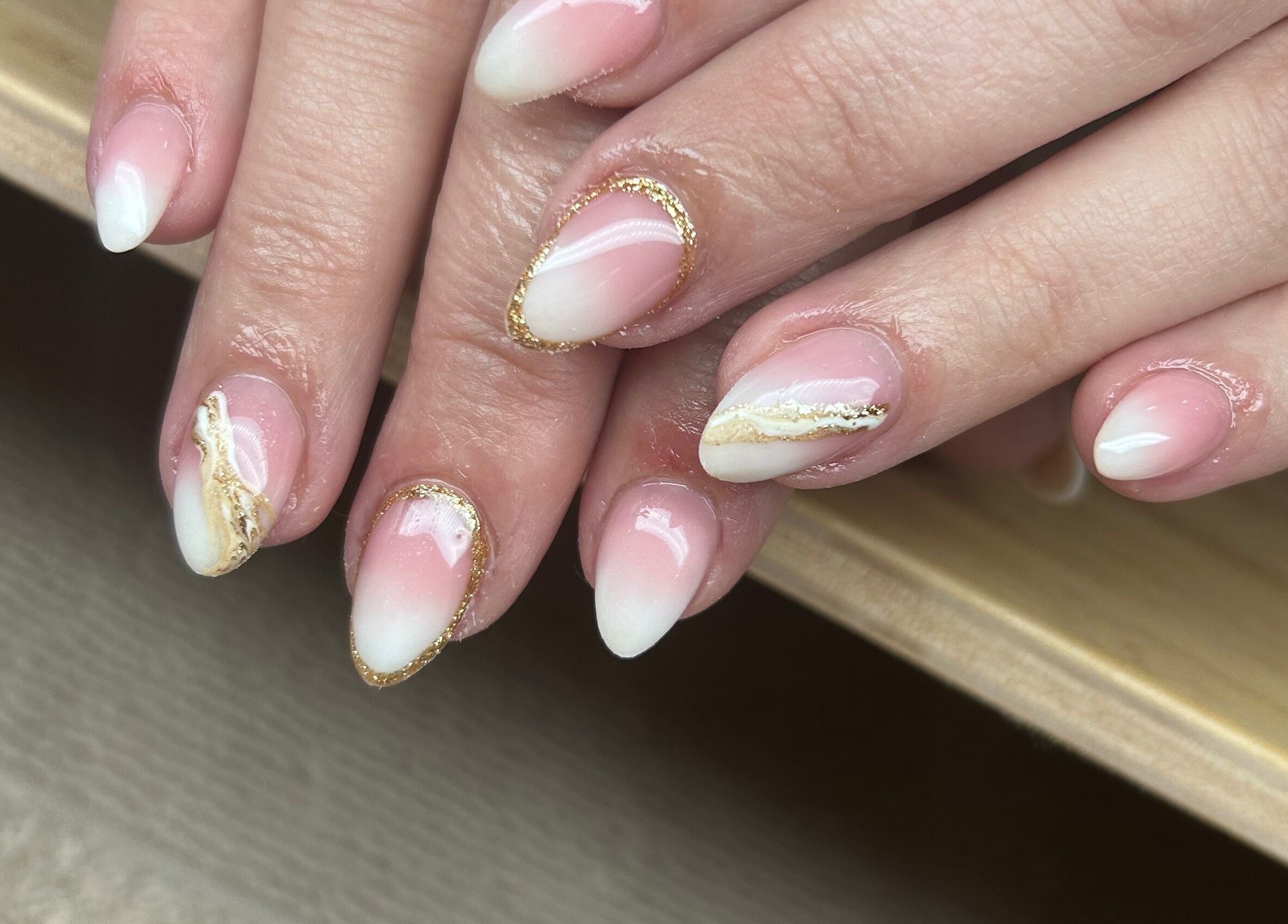 Elegant pink and white nail art at Nails By Jade, Canvey Island, England, GB. Features gold accents.
