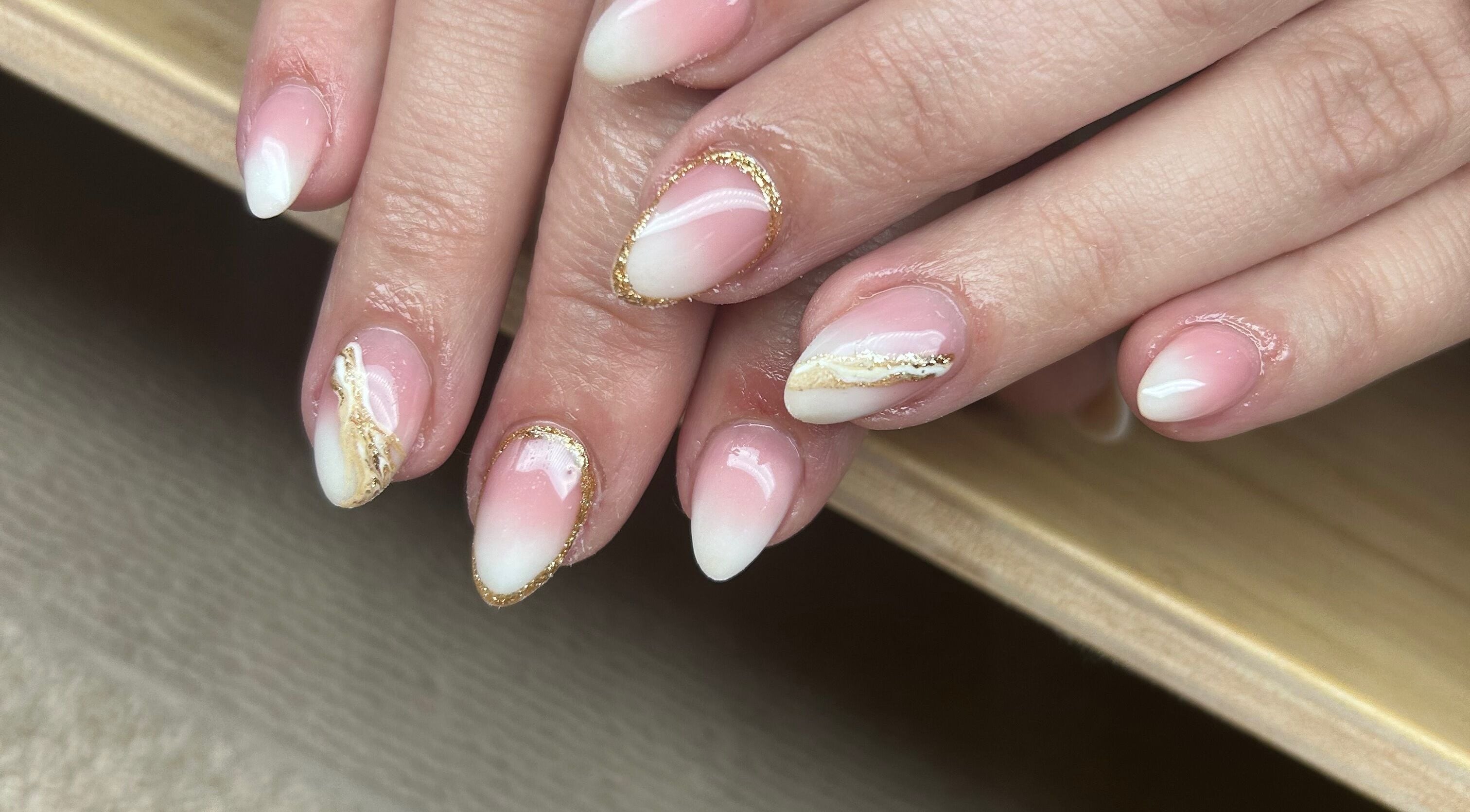 Elegant pink and white nail art at Nails By Jade, Canvey Island, England, GB. Features gold accents.