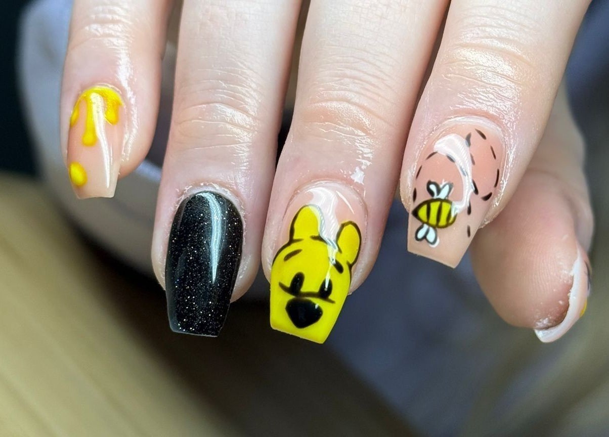 Stylish bee-themed nail art manicure at Nails By Jade, Canvey Island, England, GB. Vibrant designs showcase creativity.