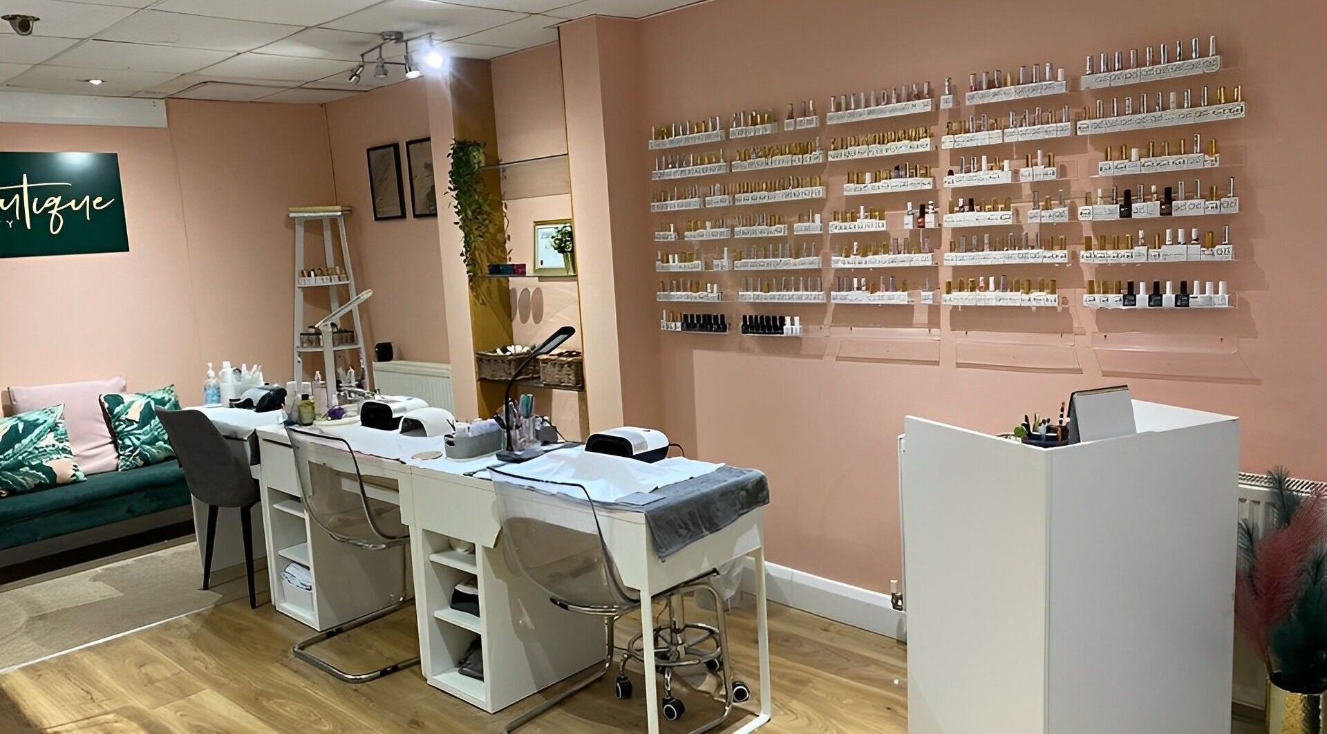 Bright nail salon interior at Beautique Beauty, Nottingham, United Kingdom, GB with modern decor and organized shelves.