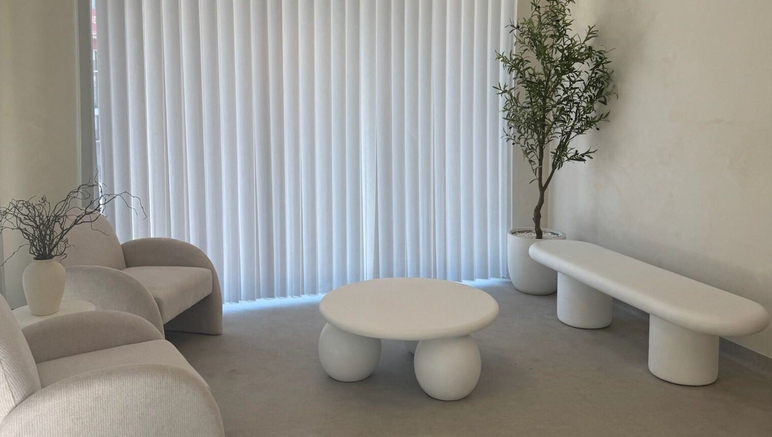 Chic minimalist lounge at Dead Pretty Beauty Bar, Singleton, New South Wales, AU, featuring modern seating and decor.