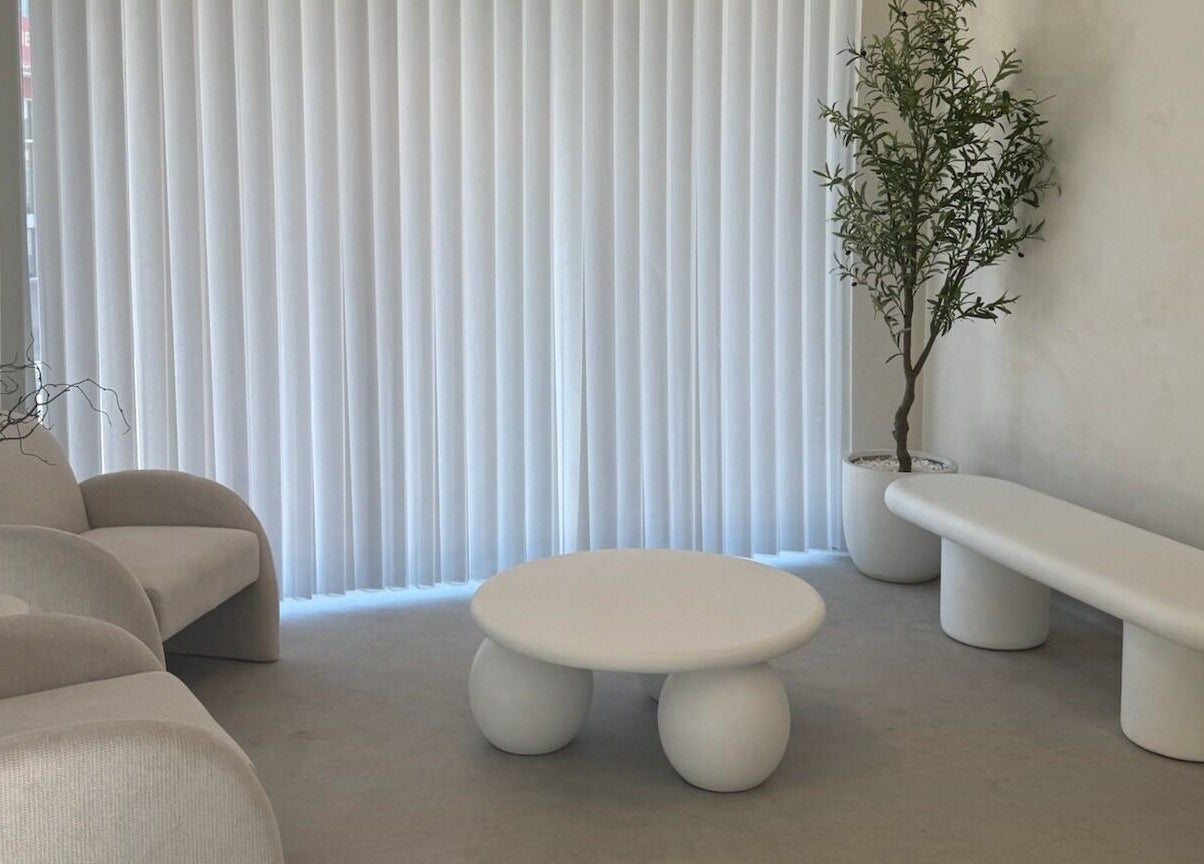 Chic minimalist lounge at Dead Pretty Beauty Bar, Singleton, New South Wales, AU, featuring modern seating and decor.