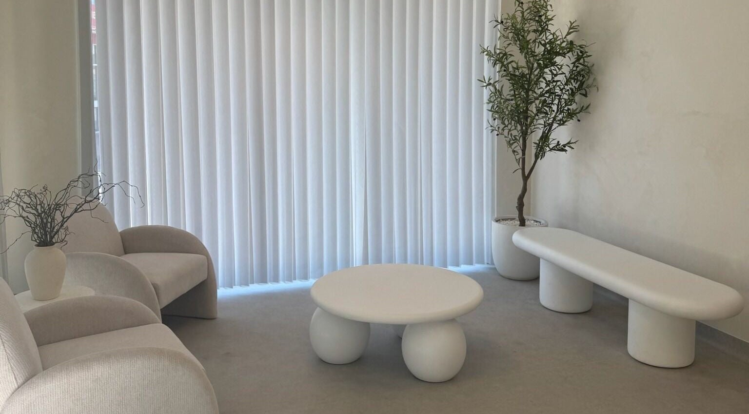 Chic minimalist lounge at Dead Pretty Beauty Bar, Singleton, New South Wales, AU, featuring modern seating and decor.