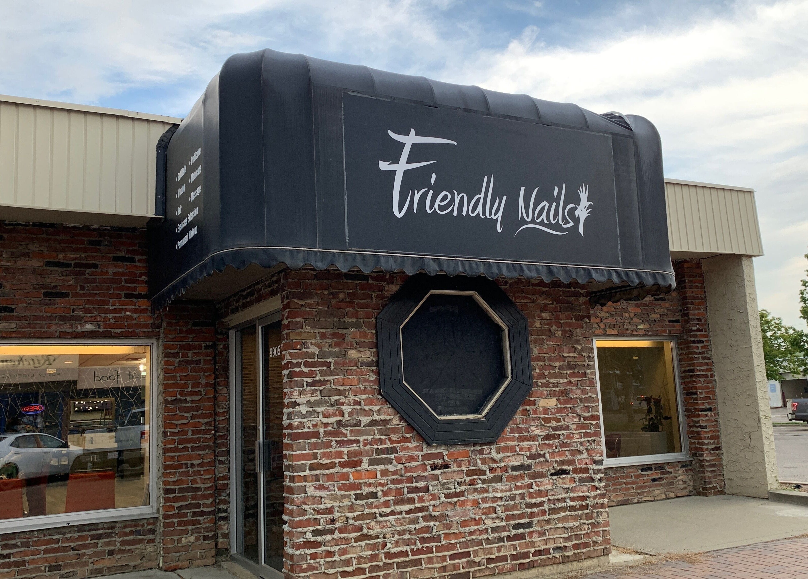 Front view of Friendly Nails - Fort Sask, a chic salon in Fort Saskatchewan, Alberta, CA with brick exterior.