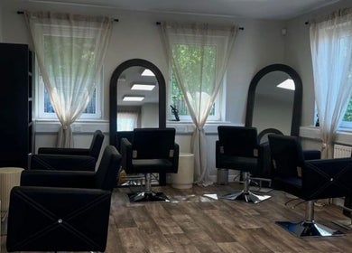Modern salon chairs and mirrors at Hair by Zoe Fellows, Corbridge, England, GB.