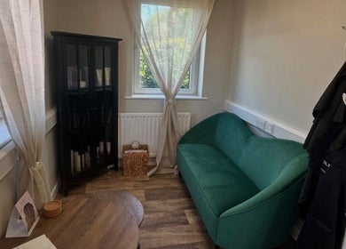 Cozy lounge area at Hair by Zoe Fellows, featuring a green sofa in Corbridge, England, GB.