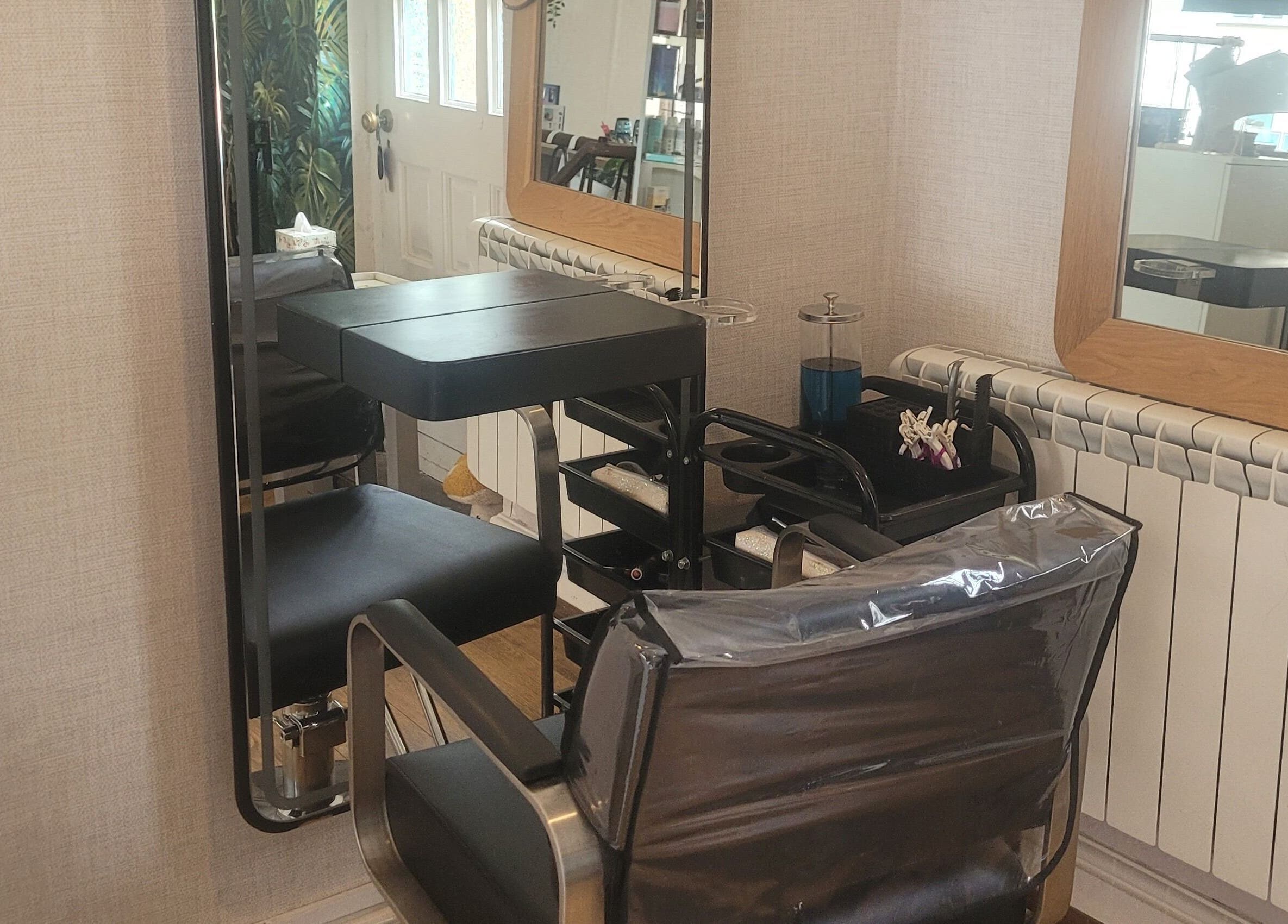 Modern salon chair and mirror at LeBris Beauty and Wellness, Saxmundham, England, GB.
