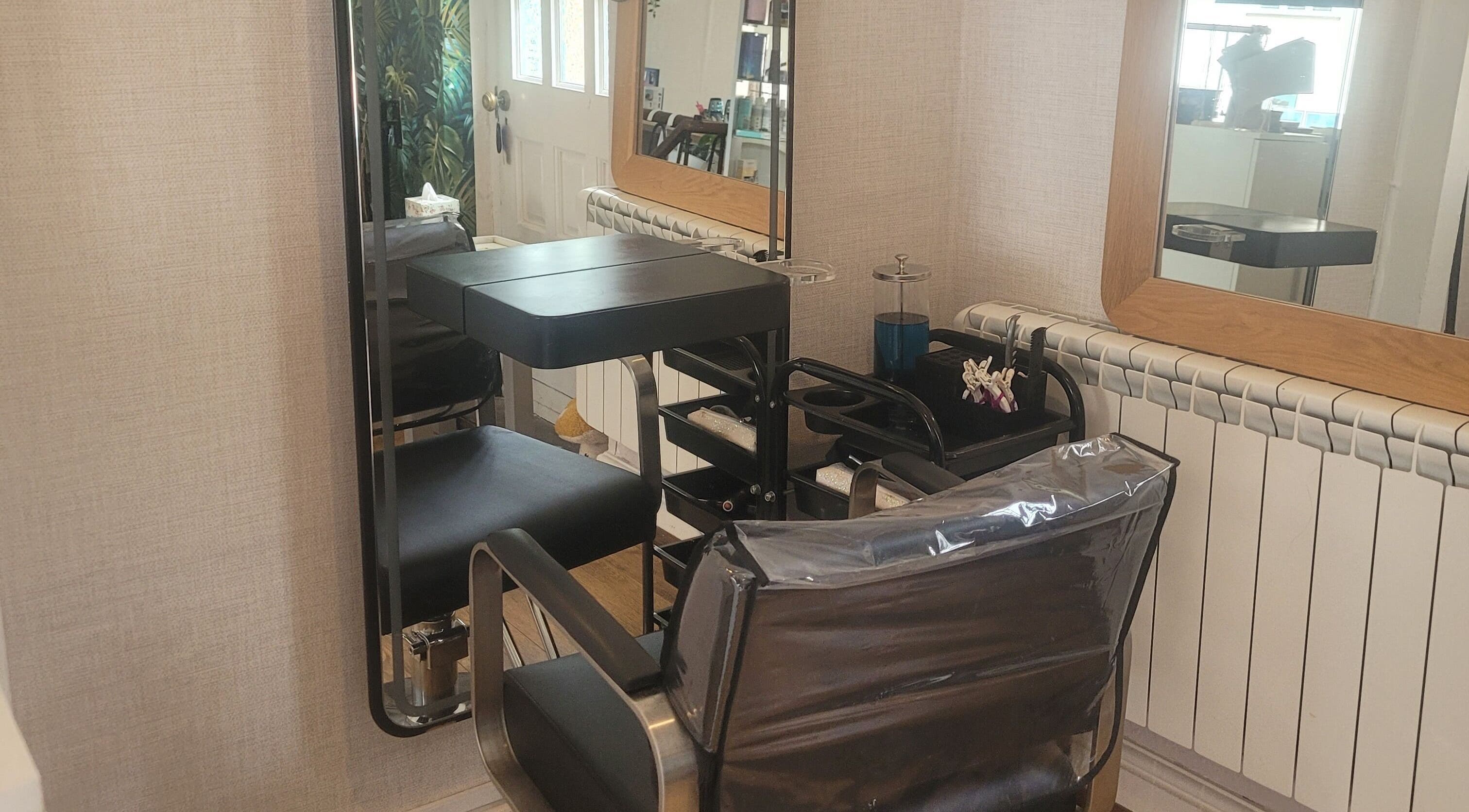 Modern salon chair and mirror at LeBris Beauty and Wellness, Saxmundham, England, GB.