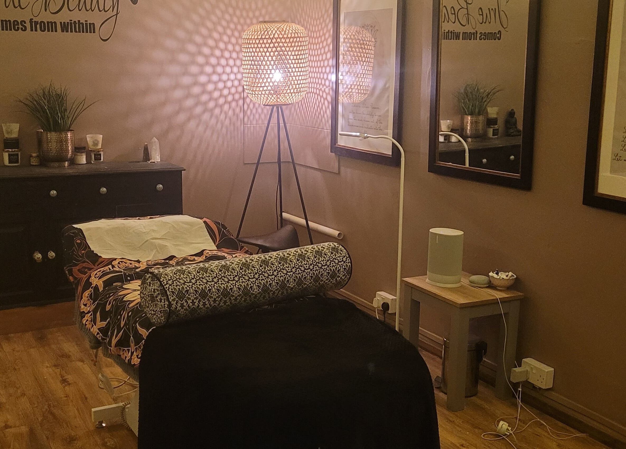 Cozy massage room at LeBris Beauty and Wellness in Saxmundham, England, GB, featuring warm lighting and elegant decor.